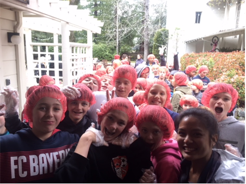 Rise Against Hunger 2018 kids in hair nets and gloves